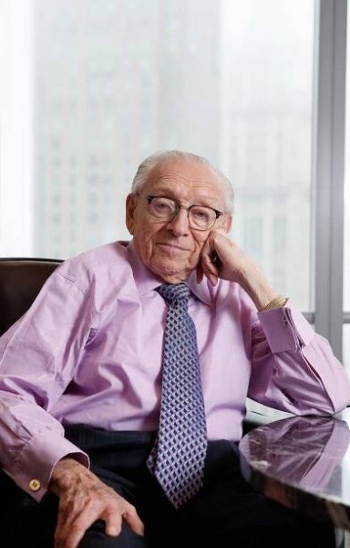 Larry Silverstein sitting in a chair with his head propped up on his hand