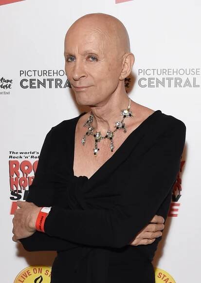 Richard O'Brien in a black shirt and necklace.
