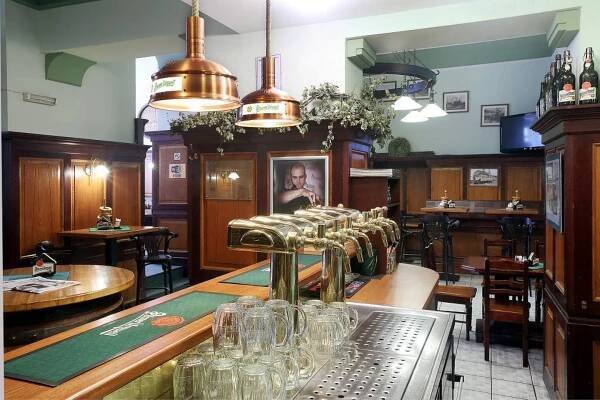 a bar with a row of glasses on a table at Hotel U Salzmannů in Pilsen