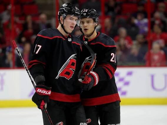Ice Hockey Superstars Sebastian Aho and Andrei Svechnikov in Action Wallpaper