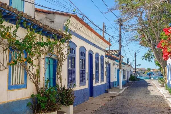 Charming street in Cabo Frio, Brazil, featuring colourful houses with vibrant facades and lush greenery | MSC Cruises
