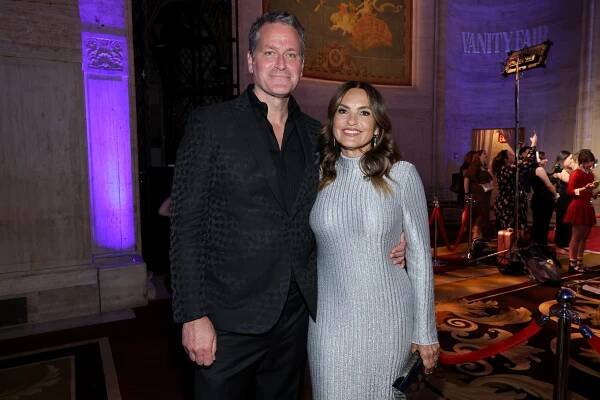 Peter Hermann and Mariska Hargitay attend The Inaugural Gotham TV Awards wearing a black suit and silver dress respectively.
