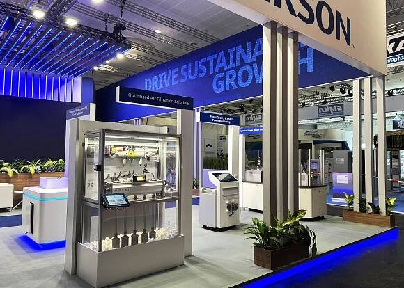 An image from the Emerson booth at the 2025 Hannover Messe trade show. This image showcases a wider view of the trade show display and exhibit space including displays with Emerson products.