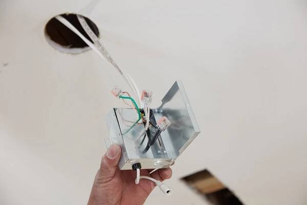 Wires and junction box pulled out of hole from recessed light