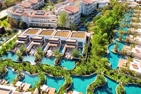 Aerial view of a resort with private pools and lush landscaping.