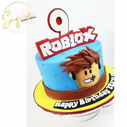 a birthday cake with the name roblox on it and an image of his face