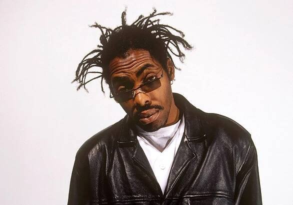 Photo of Coolio wearing a black leather jacket, blue shirt, and sunglasses.