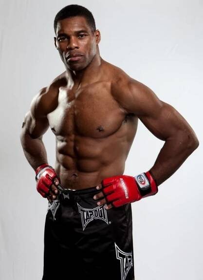 Herschel walker age 50 mma wearing gloves.
