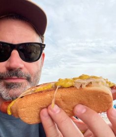 Jimmy Kimmel holding a hot dog. 