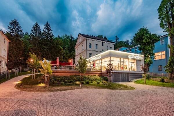 a building with a store in front of it at Vila Slavia in Luhačovice