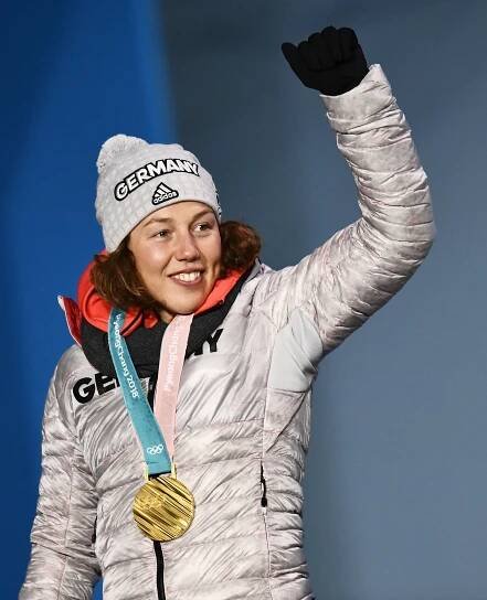 Laura Dahlmeier, German biathlete, holding up her gold medal at the 2018 PyeongChang Olympics.