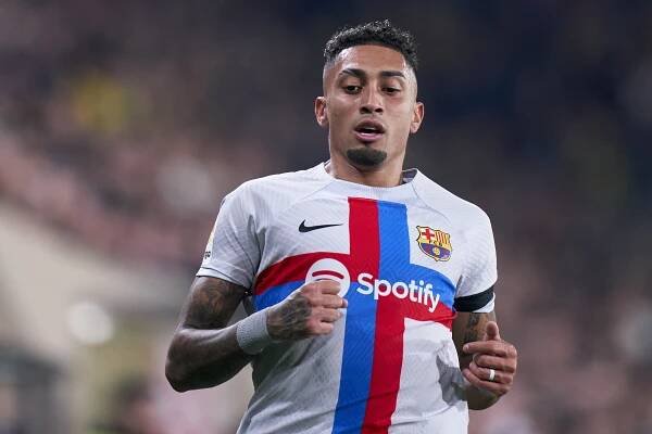 a soccer player with a spotify logo on his shirt