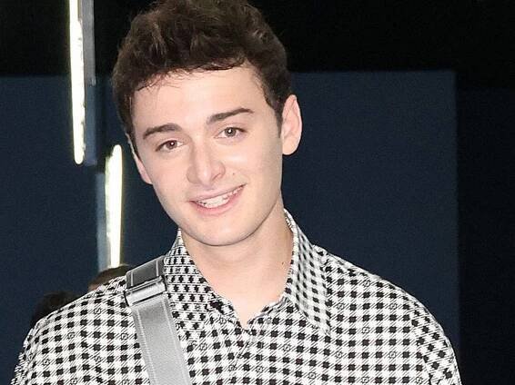 Noah Schnapp Wearing Checkered Polo Wallpaper