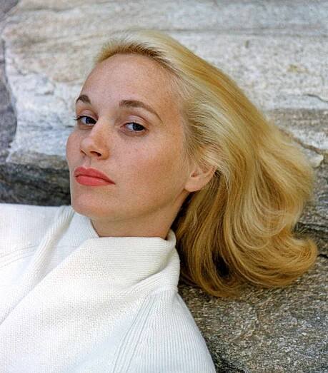 Headshot of Eva Marie Saint, US actress, wearing a white knitted cardigan, posing against a rock, circa 1960.
