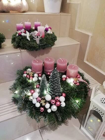 two wreaths with candles and christmas decorations