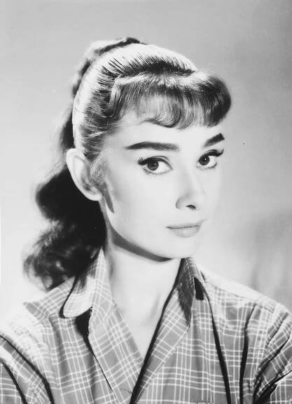 Audrey Hepburn photographed by Pierluigi Praturlon at the Cinecittà Studios in Rome, Italy, during a break from filming War and Peace, October 1955. From the personal collection of Audrey Hepburn.