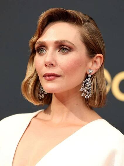 Elizabeth Olsen with an old Hollywood side-parted bob and face-framing, side-swept bangs