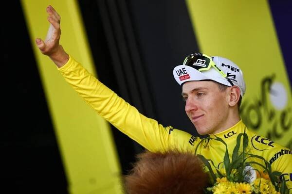 UAE Team Emirates team's Slovenian rider Tadej Pogacar celebrates on the podium with the overall leader's yellow jersey after the 6th stage of the 111th edition of the Tour de France cycling race, 163,5 km between Macon and Dijon, on July 4, 2024. (Photo by Anne-Christine POUJOULAT / AFP)
