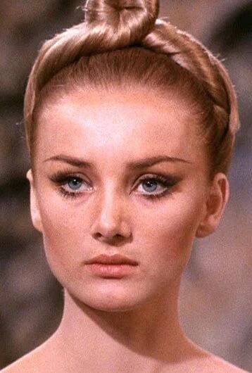 a close up of a woman with a bun in her hair