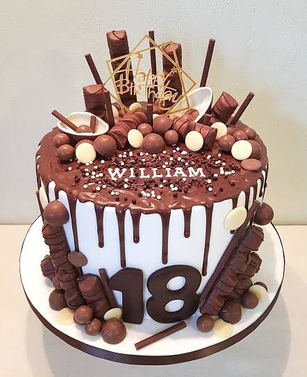 a birthday cake with chocolate icing and candies on the top that says 80