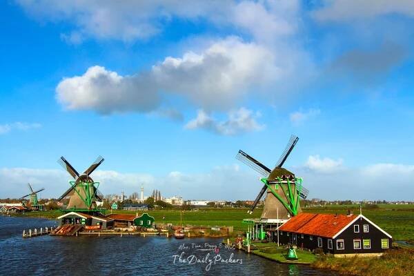 Panoramic view of windmills and farmhouses along the waterfront in Zaanse Schans.