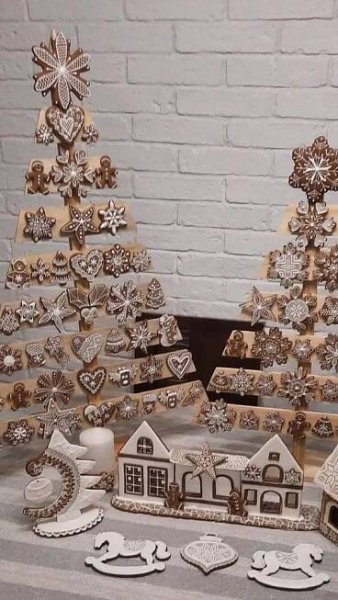 wooden christmas trees are displayed on a table