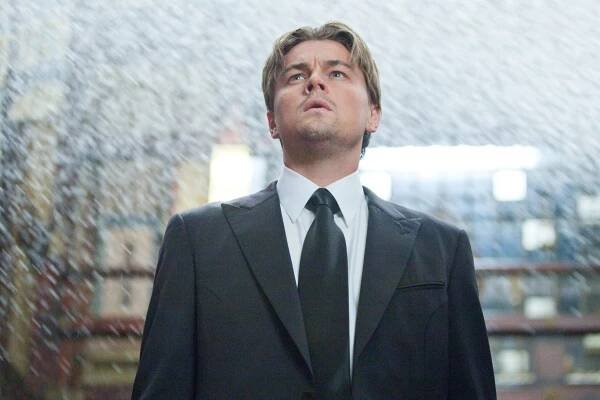 A man stands in the middle of a building being flooded by water.