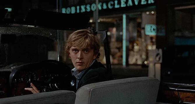 Still from *Blowup* (1966) showing David Hemmings driving a car.