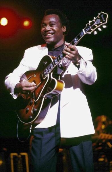 George Benson playing a guitar