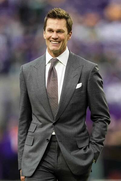 : Former NFL player Tom Brady looks on prior to a game between the Minnesota Vikings and Green Bay Packers at U.S. Bank Stadium on December 29, 2024 in Minneapolis, Minnesota. 