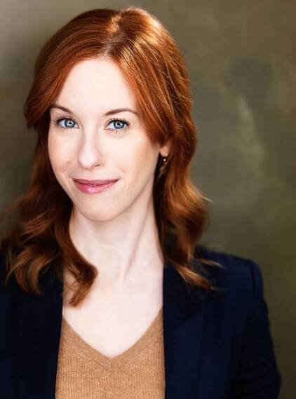 Elisabeth-Ness-Headshot-vertical-suit-eyebrow-raise-web
