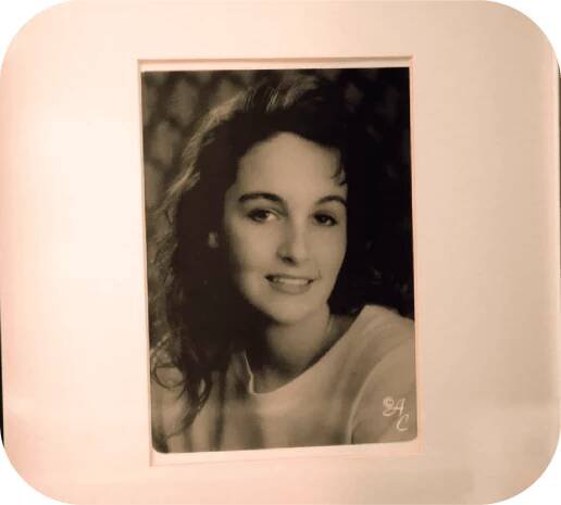 A framed photo in black and white of Jennifer from high school, before the accident.