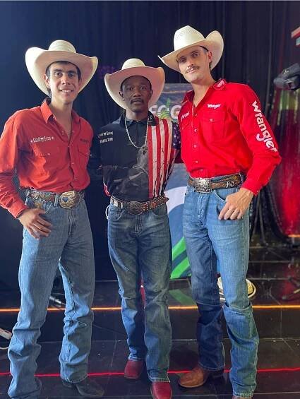 Three men in cowboy hats and Wrangler shirts.