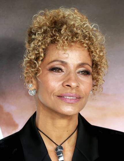Elegant Hairstyles for Women Over 50: Michelle Hurd's Curly Bangs