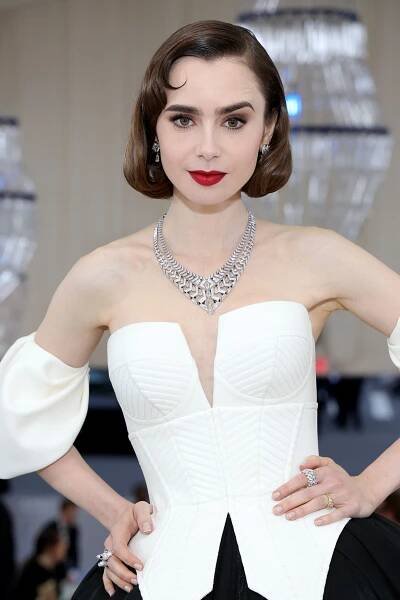 Lily Collins with a bob wearing a white gown in 2023