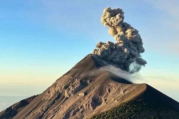 The view of an active volcano erupting from the top of Acatenango volcano in Guatemala, 
