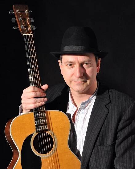 Michael holding acoustic guitar