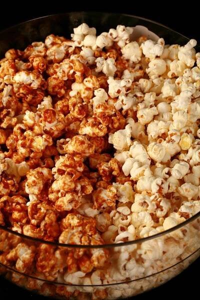 Close up photo of a bowl of two-tone popcorn: Maple White Cheddar Popcorn. Half of the popcorn is covered with maple caramel, the other half is white - white cheddar.