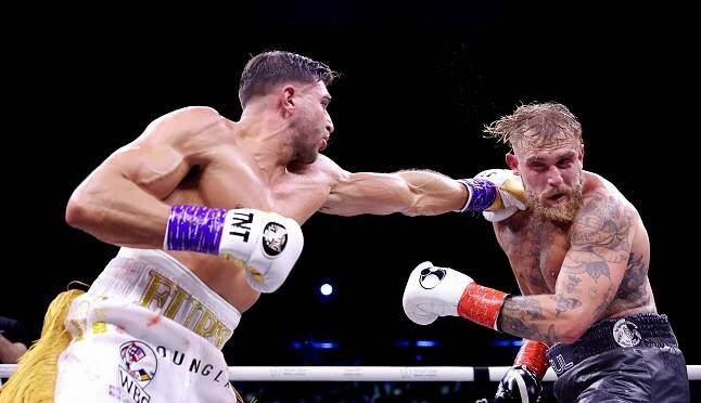 two boxers are fighting and one has a belt that says jungle