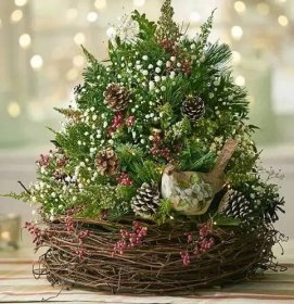 a bird nest filled with pine cones, berries and greenery
