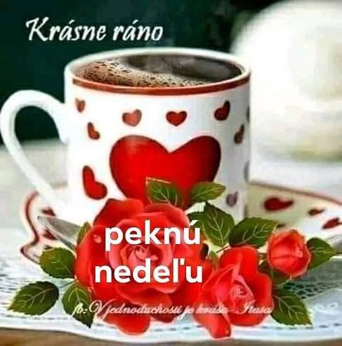 there is a coffee cup and saucer on the table with red roses in it