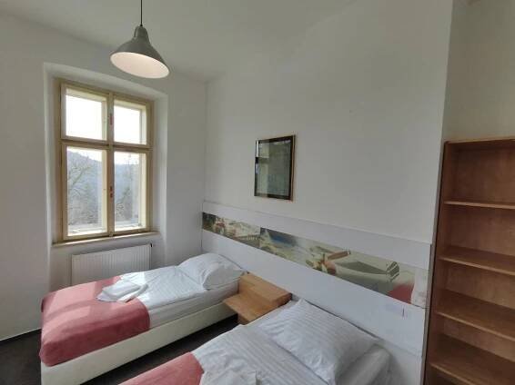 a bedroom with two beds and a window at Hotel Stará Škola in Mezná