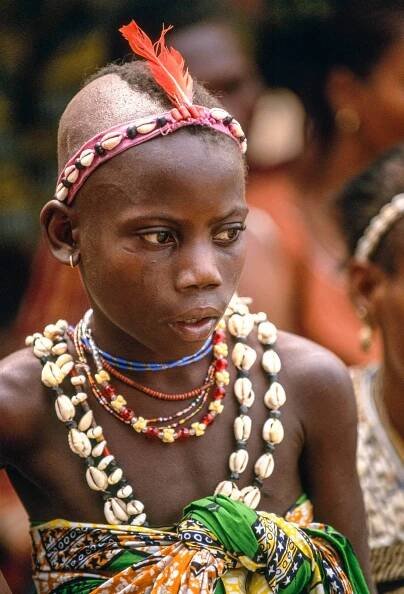 Young Voodoo Priestess with Red Parrot Feather, Benin