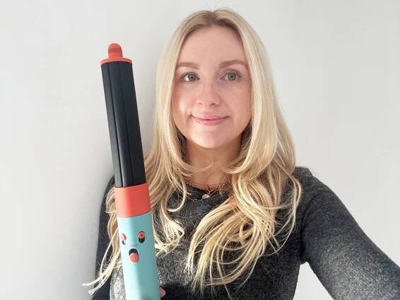 Sun Shopping fashion and beauty writer Sophie Bates holds the Dyson Airwrap i.d.
