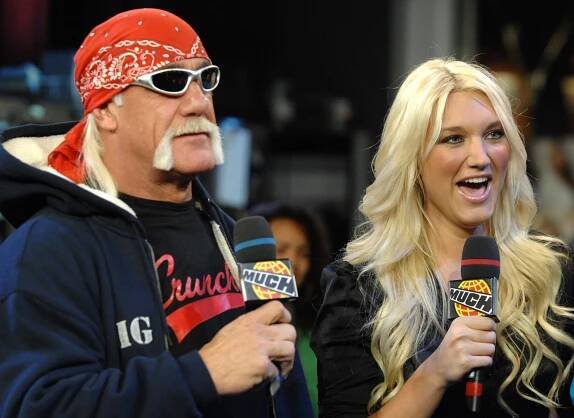 Hulk Hogan and Brooke Hogan holding microphones.