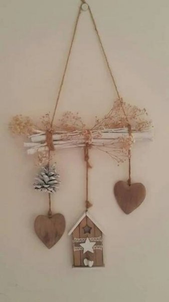 a wall hanging with three hearts and a bird house on it's back side