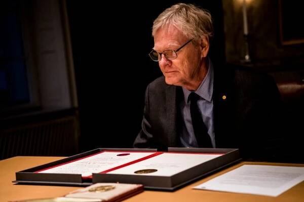 A man looks at his diploma