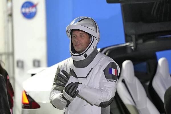 European Space Agency astronaut Thomas Pesquet of France, adjusts his glove as he talks to family and friends before a launch attempt at the Kennedy Space Center on April 23, 2021 in Cape Canaveral, Fla.