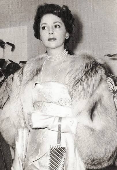an old photo of a woman in a fur coat