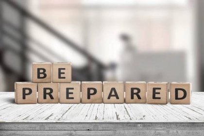 Be prepared phrase on wooden dices in a bright room on an old desk — Stock Image